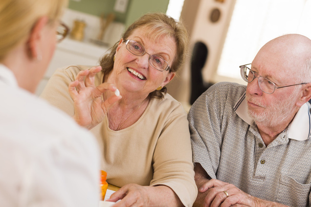Doctor or Nurse Explaining Prescription Medicine to Senior Coupl - Photo, Image