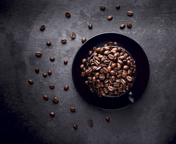 Coffee beans in the black cup on the black background - Photo, Image