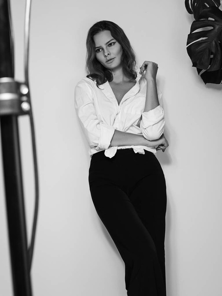 Attractive Sensual Woman is Posing in White Shirt. Black and White Cinematic Portrait with Cute Emotions. - Valokuva, kuva