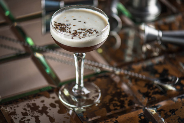 Cocktail in glass on brown tiled background - Fotó, kép