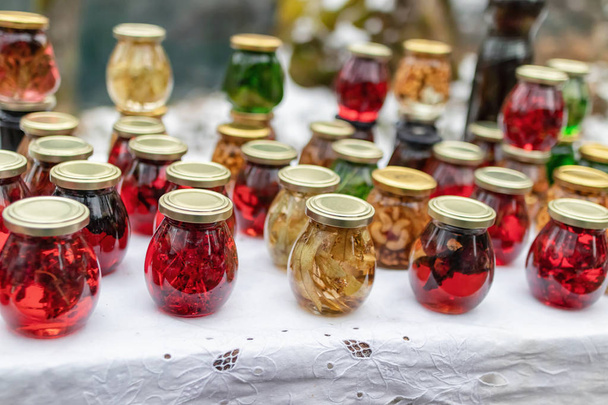 Small jars with exotic mountain jams: from fir cones, cranberries, sea buckthorn and herbs - Zdjęcie, obraz