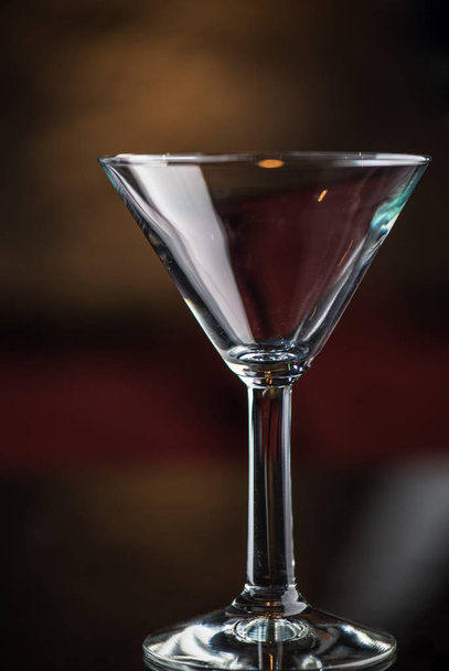 close-up of cocktail glass on dark blurred background - 写真・画像