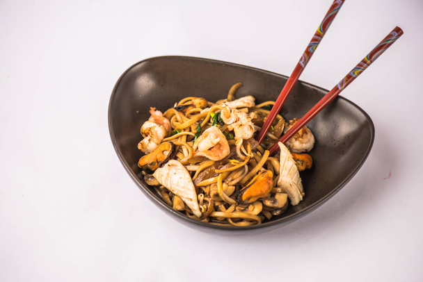 Bowl of asian seafood noodles on white background - Fotó, kép