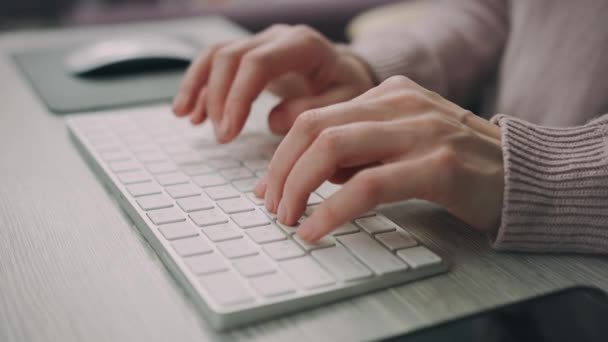 Female hands typing on modern keyboard. Freelance worker typing keyboard - Footage, Video