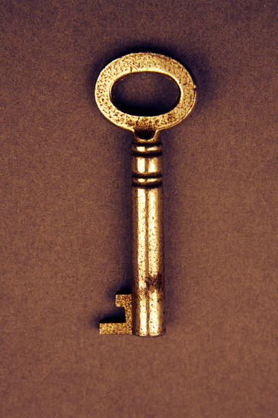 Key on brown background - Foto, Imagen