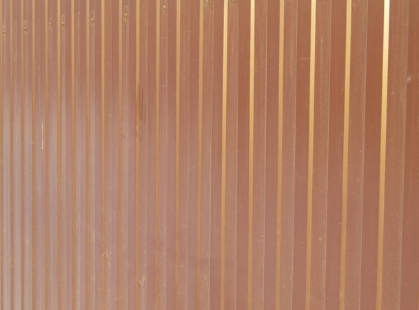 Brown metal siding, modern finishing material for the manufacture of fences and exterior wall cladding. - Photo, Image