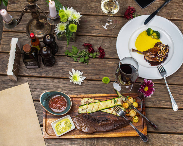 wooden setting table with meat dishes served on white plates - Fotoğraf, Görsel