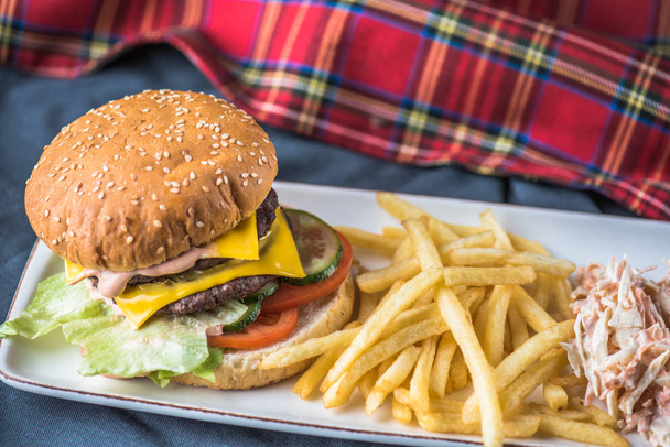 Burger with potato fries served on plate on tablecloth - Zdjęcie, obraz