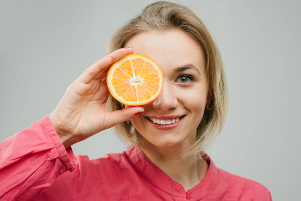 menina atraente alegre sorridente com citrinos em mãos
 - Foto, Imagem