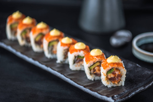 Japanese sushi roll served on black plate - Φωτογραφία, εικόνα