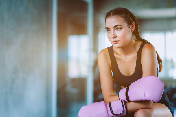Fit beautiful young woman muay thai boxer exercise class in a gym. Healthy, sport, lifestyle, Fitness, workout concept. With copy space. - Foto, afbeelding