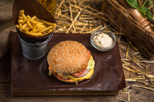 Tasty burger with french fries on wooden board - Fotoğraf, Görsel