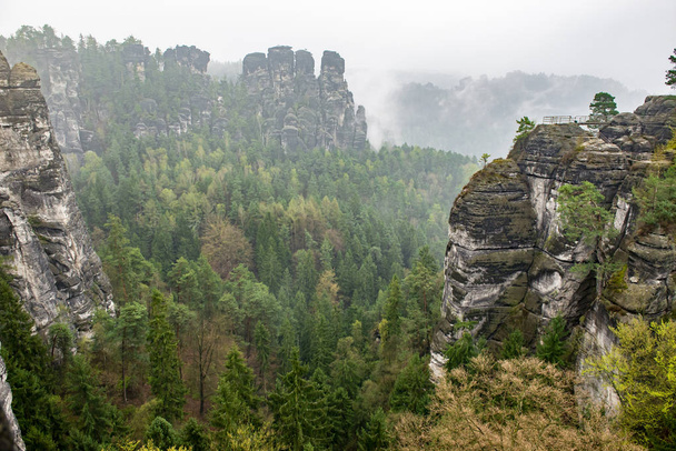 Bastei Dresden Germany.Park Saxon Switzerland.The cliffs are located not far from Rathen near the town of Pirne in the south-east of Dresden.The rocks in the fog.Beautiful landscape.Mountains travel. - Photo, Image