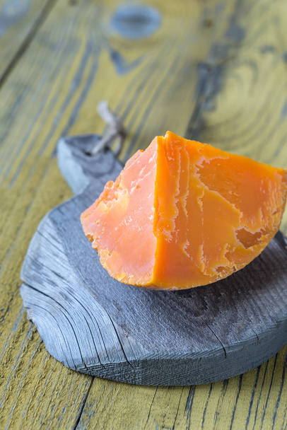 Wedge of Mimolette cheese on the wooden board - Photo, Image