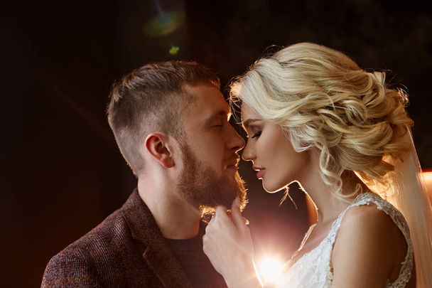 Couple hugged and kissed after the marriage. The bride and groom hug each other and look into their eyes. Love, tenderness, faithfulness and care in every touch. Happy couple - Zdjęcie, obraz