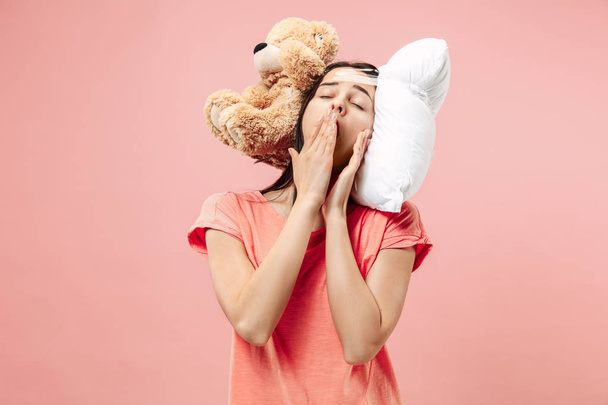 Tired woman sleeping at home having too much work. Bored businesslady with pillow and toy bear - Fotoğraf, Görsel