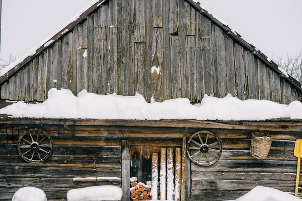 wooden country house covered with fallen snow - 写真・画像