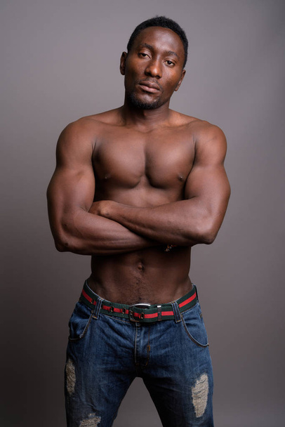 Joven hombre africano guapo sin camisa sobre fondo gris
 - Foto, Imagen