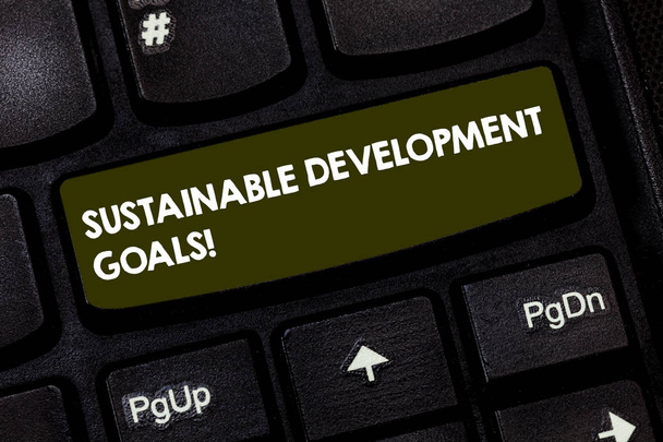 Writing note showing Sustainable Development Goals. Business photo showcasing Unite Nations Global vision for huanalysisity Keyboard key Intention to create computer message pressing keypad idea. - Photo, Image
