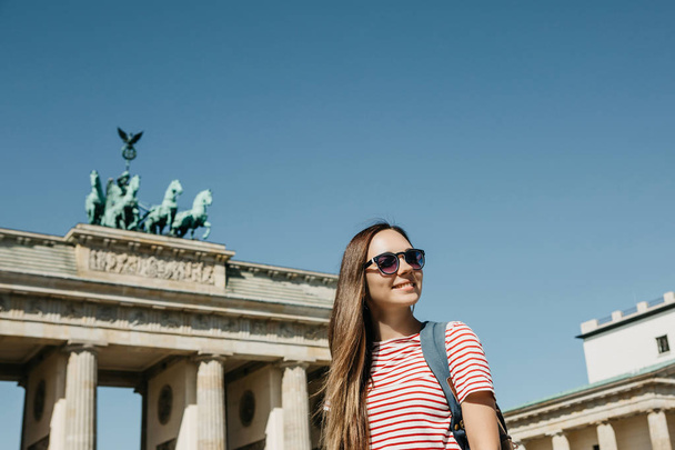 Portrait of a young beautiful positive smiling stylish tourist girl. - 写真・画像