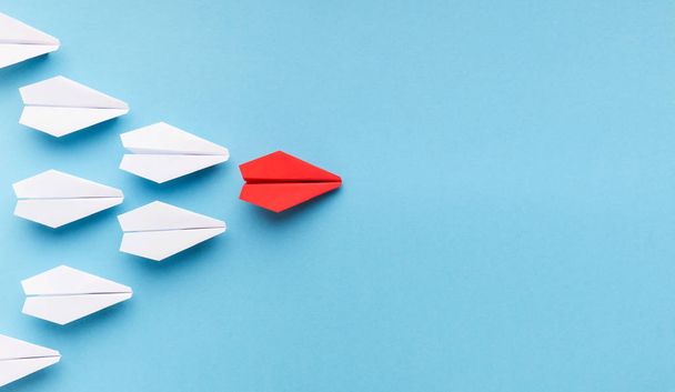 One blue paper plane leading group of white ones - Photo, Image
