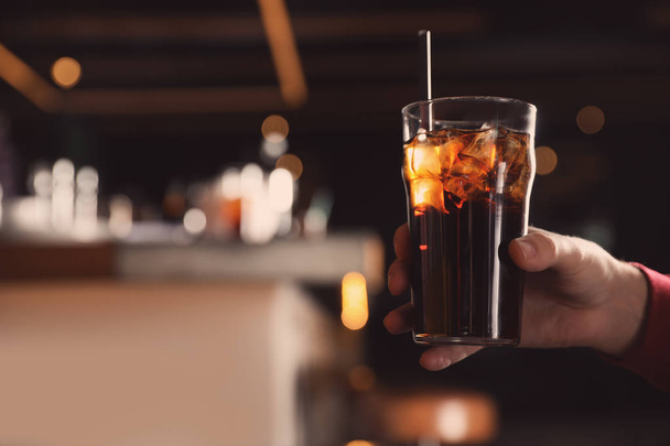 Man holding glass of refreshing cola indoors, closeup. Space for text - Fotografie, Obrázek