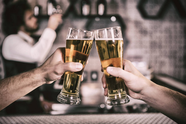 Cropped image of men toasting beer glass at bar - Foto, Imagem
