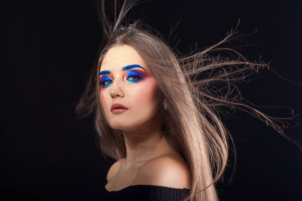 Attractive brunette with bright stylish make-up. Colored Smokey eyes and blue eyebrows. - Zdjęcie, obraz