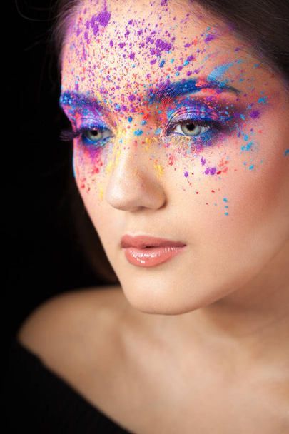 Attractive brunette with bright art make-up. Colored Smokey eyes and blue eyebrows. - Фото, изображение