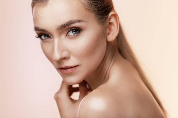 Beautiful Young Girl With Perfect Skin On Beige Background. Skin Care Concept  - 写真・画像