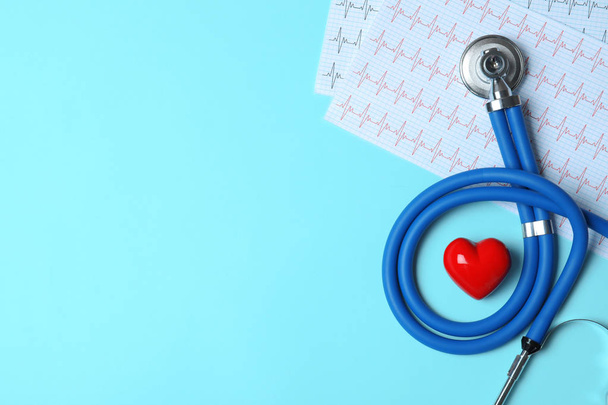 Stethoscope with red heart and cardiogram on blue background, flat lay. Space for text - Fotó, kép