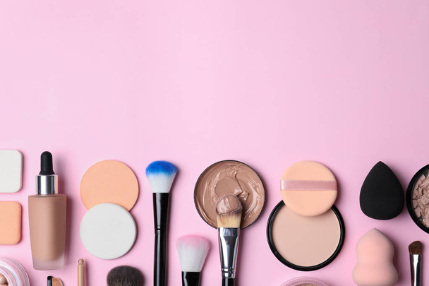 Flat lay composition with skin foundation, powder and beauty accessories on color background. Space for text - Фото, изображение