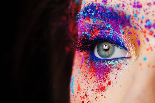 explosion of color, multi-colored shadows scattered on the eyelids. Colored Smokey eyes and blue eyebrows. - Photo, Image