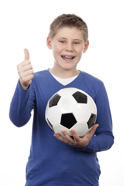 Young boy holding a football ball - Foto, imagen