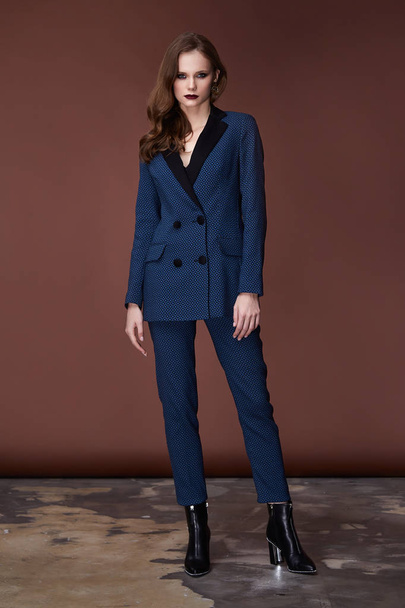 Beautiful sexy young business woman dark hair evening makeup wearing formal suit jacket pants high heels shoes business clothes for meetings walks autumn spring collection perfect body shape make-up. - Foto, Bild