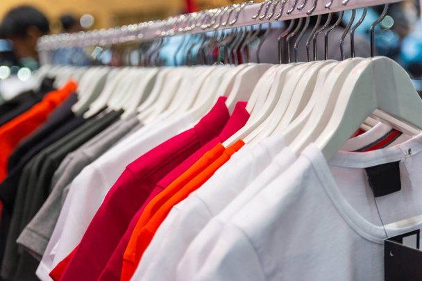 Colorful t-shirt on hangers for sale in department stores. - Photo, Image