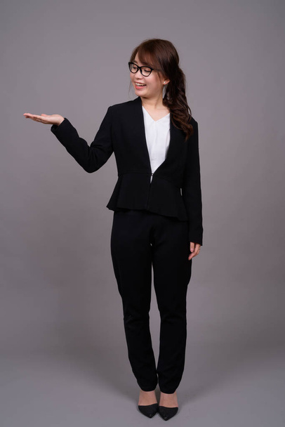 Full length portrait of young Asian businesswoman standing - Zdjęcie, obraz