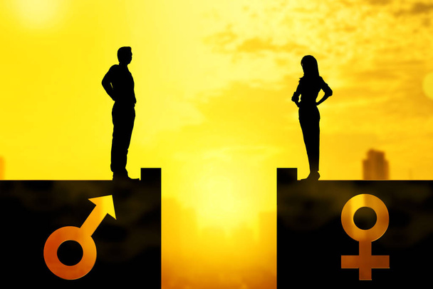 Silhouette of businessman and businesswoman standing on rooftop with same height - Valokuva, kuva