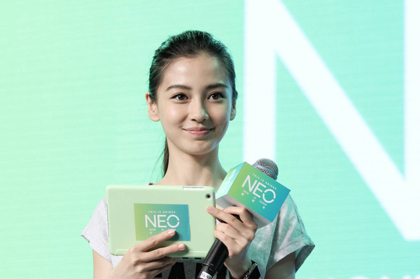 Hong Kong actress Angelababy smiles during a promotional event for Adidas NEO Label in Shanghai, China, 28 April 2015. - Фото, зображення