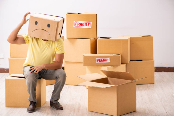 Unhappy man with box instead of his head  - Photo, Image