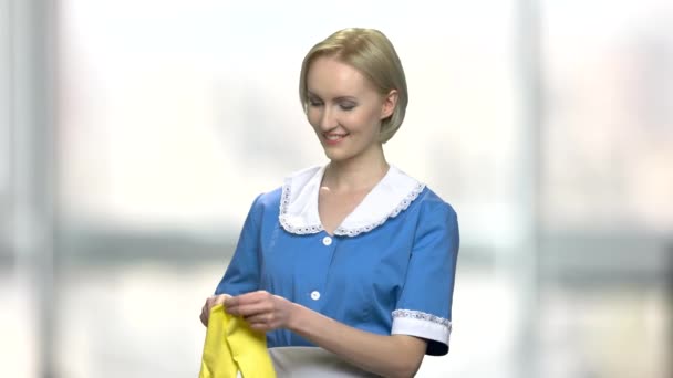 Cheerful woman cleaner puts on gloves. - Footage, Video