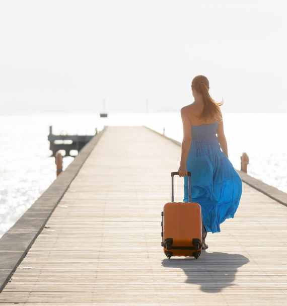 Young woman walking on wooden pier - Zdjęcie, obraz