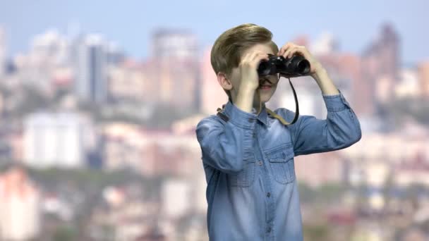Cute preteen boy looking through binoculars. - Footage, Video