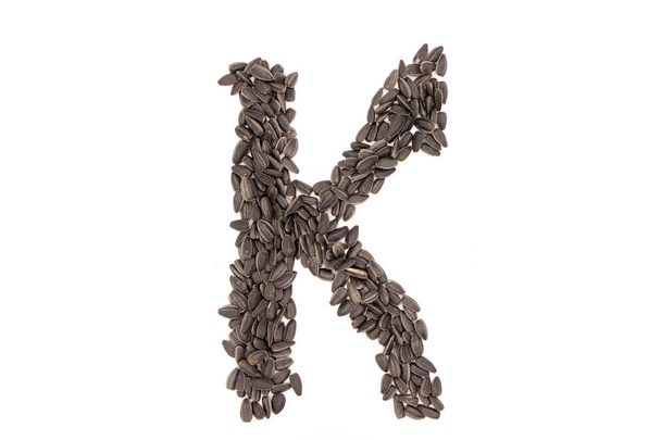 Alfabeto de sementes de girassol preto isolado no fundo branco
 - Foto, Imagem