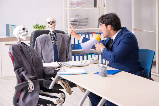 Grappige zakelijke ontmoeting met baas en skeletten - Foto, afbeelding