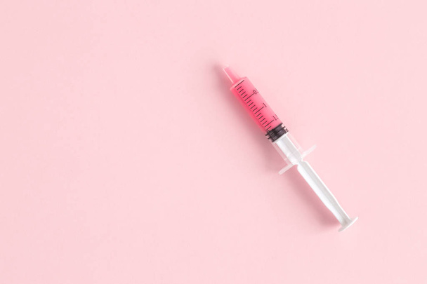 Flat lay of syringe isolated on pink background minimal creative concept. Space for copy. - Photo, Image