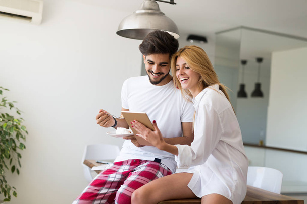 Happy couple in love surfing on tablet at home - Fotó, kép