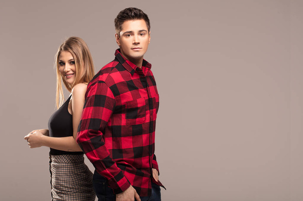 Young beautiful couple posing together in fashionable clothes. - Zdjęcie, obraz