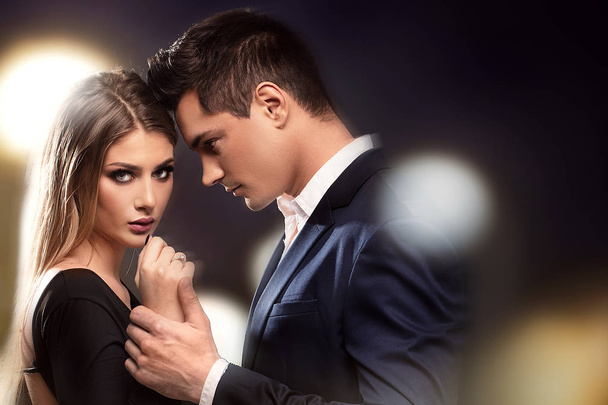 Young beautiful couple posing together in elegant clothes. - Foto, Bild