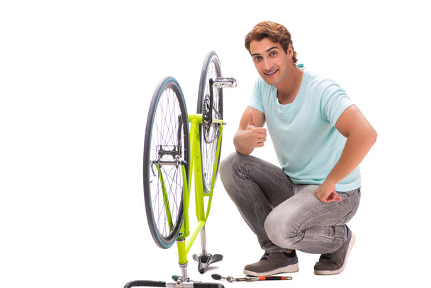 Man repairing his bike isolated on white background - Foto, afbeelding